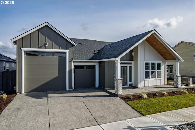 view of front facade with board and batten siding, concrete driveway, a garage, and roof with shingles