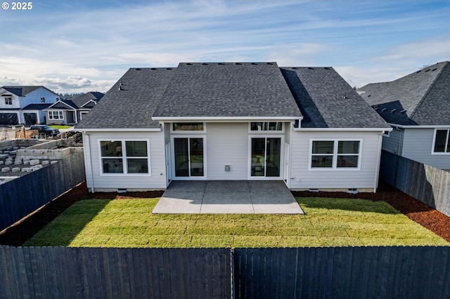 back of house with a shingled roof, a patio area, a lawn, a fenced backyard, and crawl space