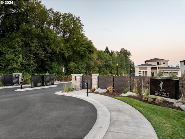 view of property's community featuring a gate, fence, and mail area