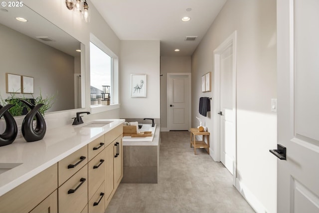 full bathroom with visible vents, a garden tub, a sink, recessed lighting, and double vanity