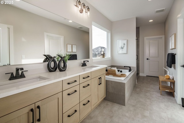 full bathroom featuring a shower stall, a bath, visible vents, and a sink