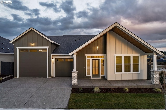 view of front of property featuring board and batten siding, concrete driveway, an attached garage, and a shingled roof