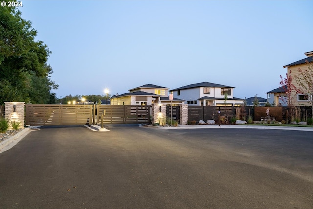 view of front of house featuring fence and a gate