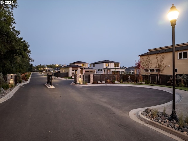 view of road with a residential view, curbs, and street lighting