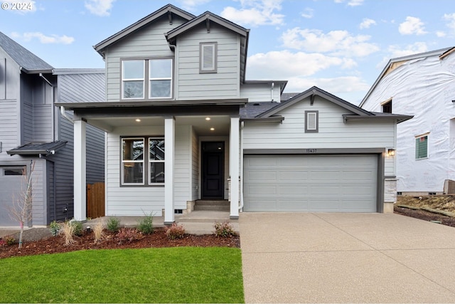 view of front of house featuring a garage and a front yard