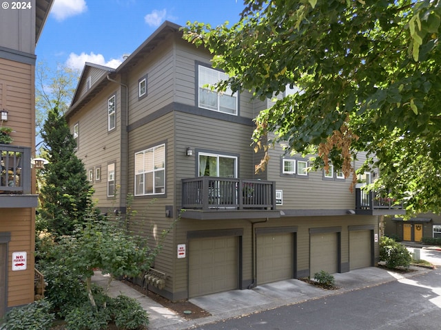 view of front of house featuring a balcony and a garage