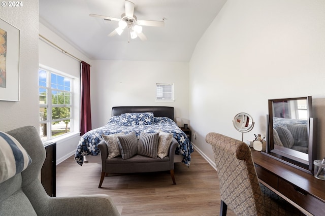 bedroom with light wood-type flooring, ceiling fan, and vaulted ceiling