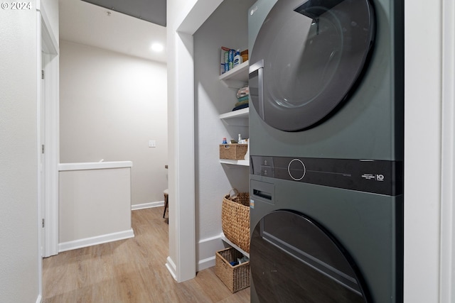 washroom featuring light wood-type flooring and stacked washer and dryer