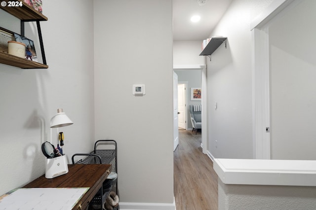 hallway with light hardwood / wood-style floors