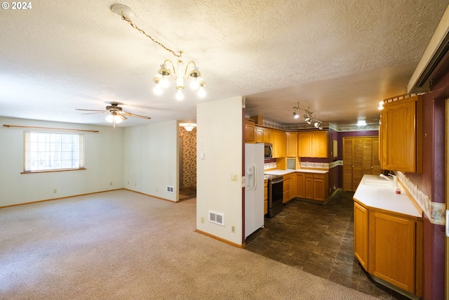 kitchen featuring stainless steel appliances, dark colored carpet, light countertops, visible vents, and a sink