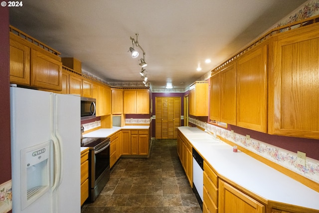 kitchen featuring appliances with stainless steel finishes, light countertops, and a sink