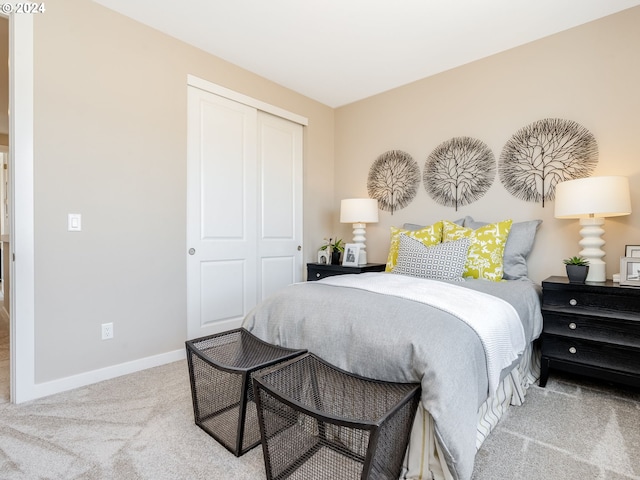 bedroom with light colored carpet and a closet