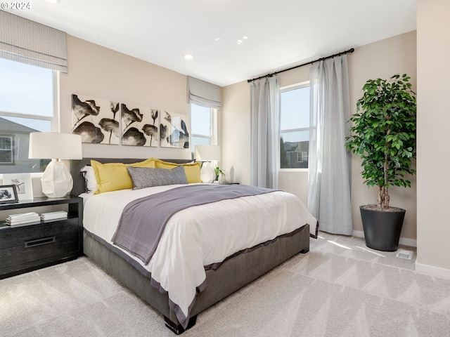 bedroom with light colored carpet