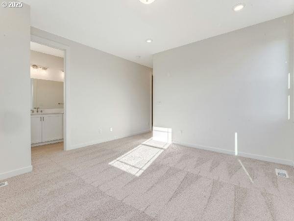 unfurnished room featuring recessed lighting, baseboards, and light colored carpet