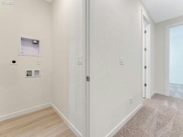 hallway featuring light wood-type flooring and baseboards