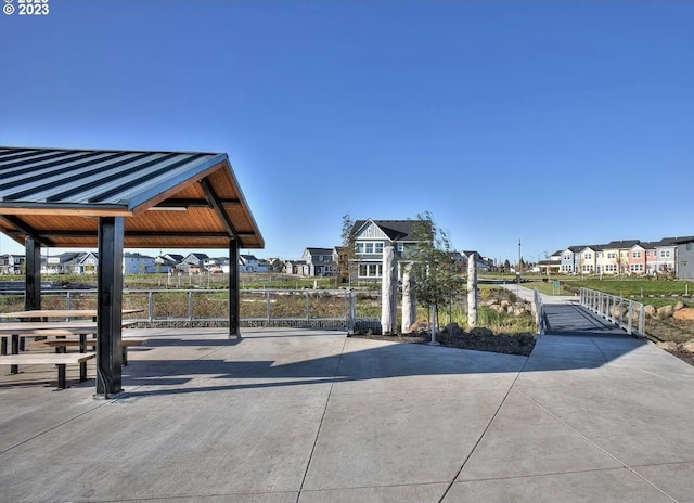 view of community featuring a gazebo, fence, and a residential view