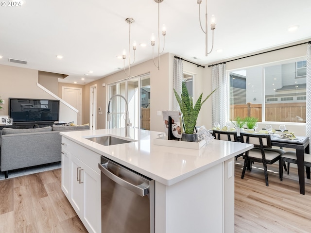 kitchen featuring dishwasher, an island with sink, hanging light fixtures, and sink