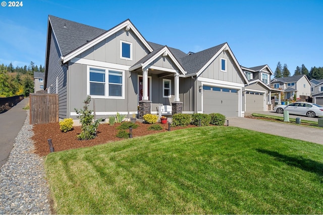 craftsman inspired home featuring a front yard and a garage