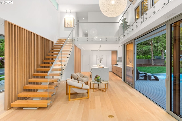 interior space featuring a towering ceiling and wood-type flooring