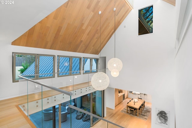 interior space with hardwood / wood-style flooring and high vaulted ceiling