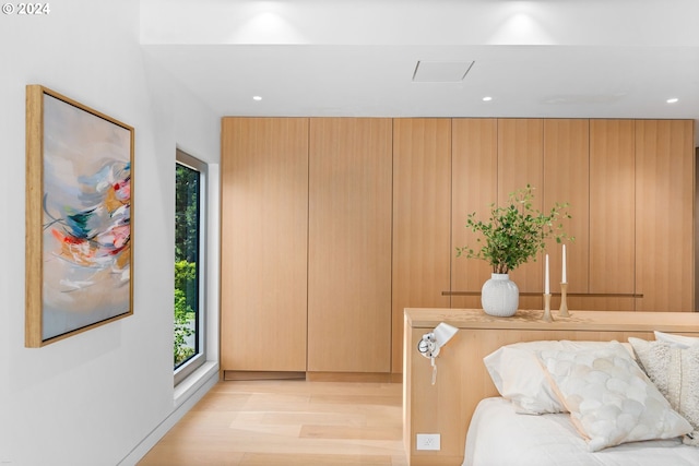 interior space with multiple windows, wood walls, and light hardwood / wood-style floors