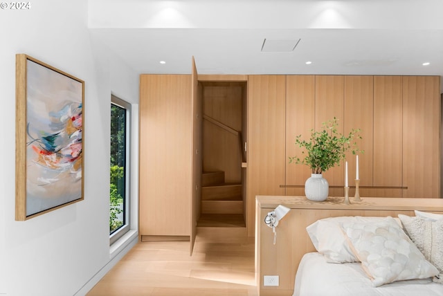 bedroom featuring wood walls and light hardwood / wood-style flooring