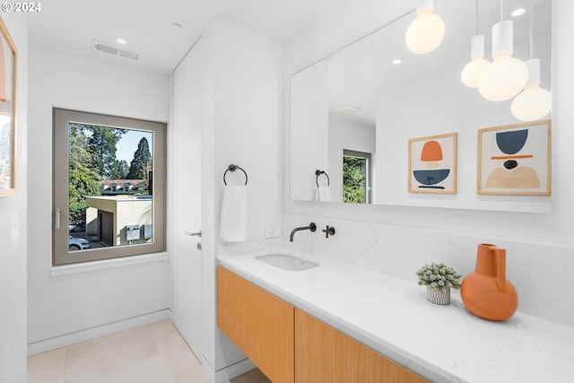 bathroom with tile patterned flooring and vanity