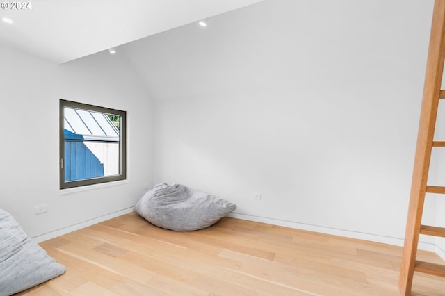 sitting room with hardwood / wood-style flooring and lofted ceiling