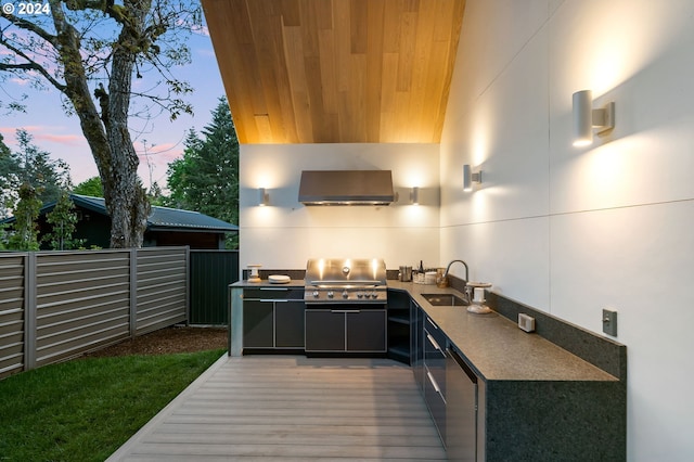 kitchen featuring wall chimney range hood, stainless steel refrigerator, sink, and dark hardwood / wood-style flooring