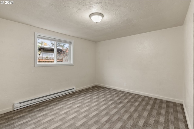 carpeted spare room featuring a textured ceiling and a baseboard heating unit