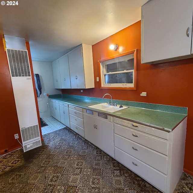 kitchen with white cabinetry and sink