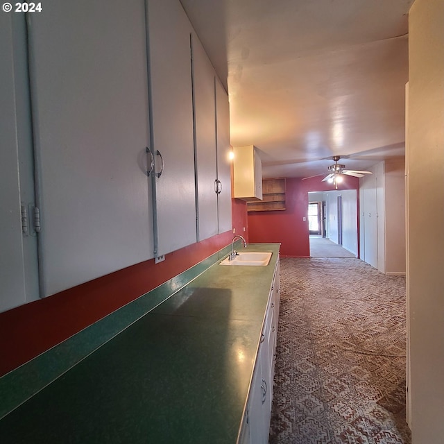 corridor featuring sink and carpet floors