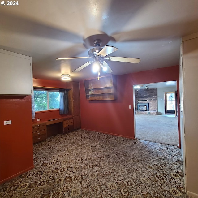 carpeted spare room with ceiling fan