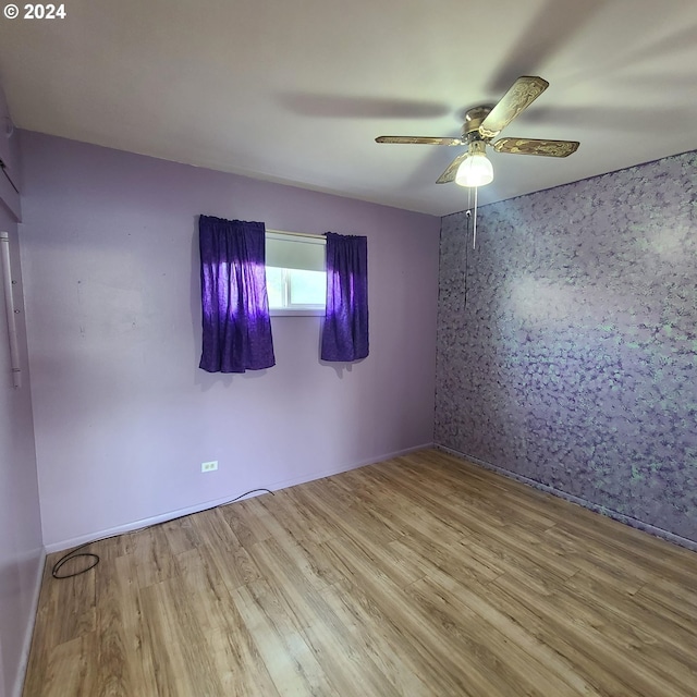 unfurnished room featuring ceiling fan and light hardwood / wood-style flooring