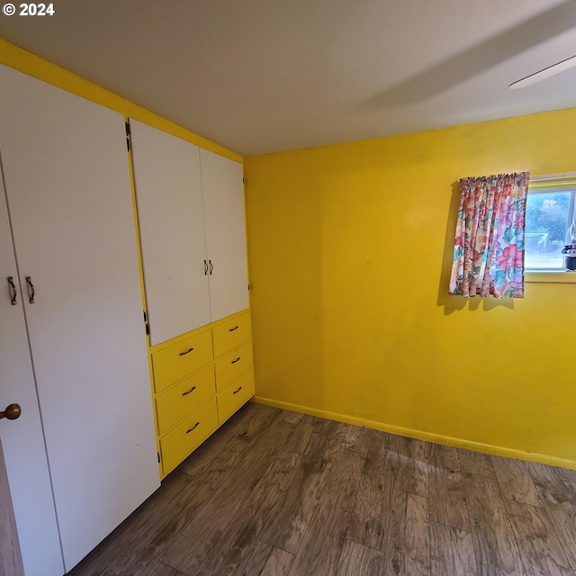 unfurnished bedroom featuring dark wood-type flooring