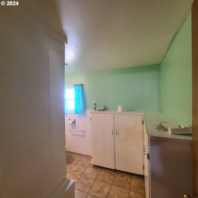 laundry area with light tile patterned flooring