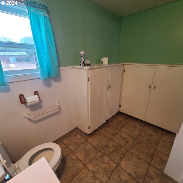 bathroom with tile patterned flooring and toilet