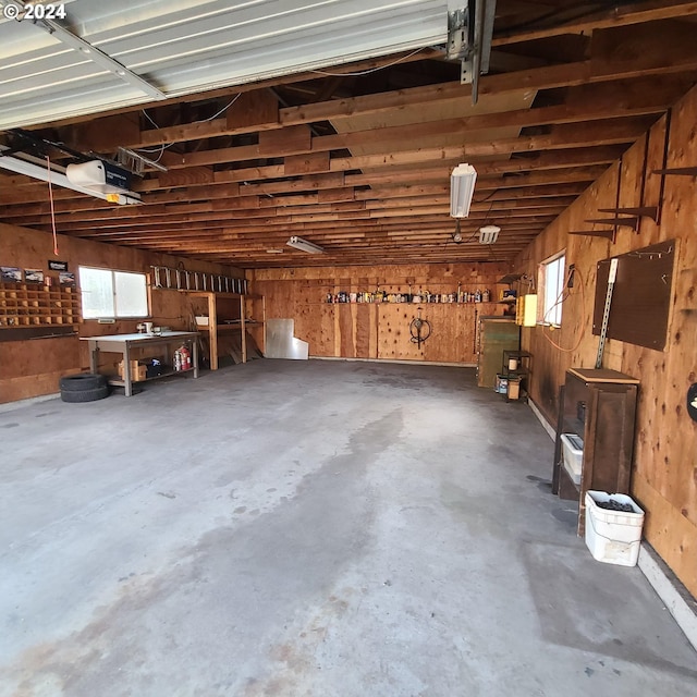 garage with a workshop area and a garage door opener