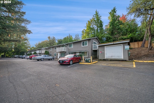 view of front of house with a garage and an outdoor structure