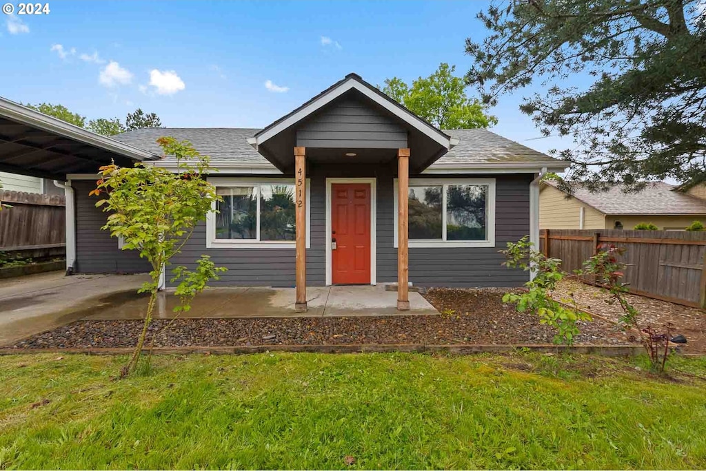 bungalow-style house featuring a front yard