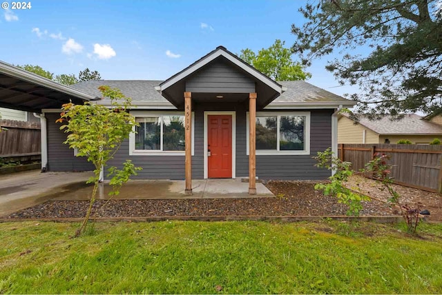 bungalow-style house featuring a front yard