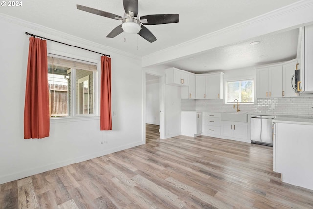 kitchen with light hardwood / wood-style floors, appliances with stainless steel finishes, and white cabinetry