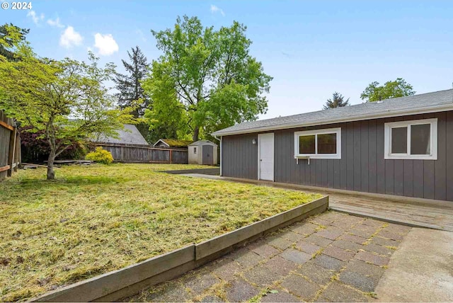 view of yard with a storage unit and a patio area