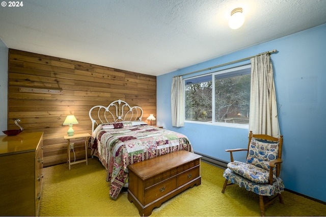 bedroom with wood walls, light colored carpet, and a textured ceiling