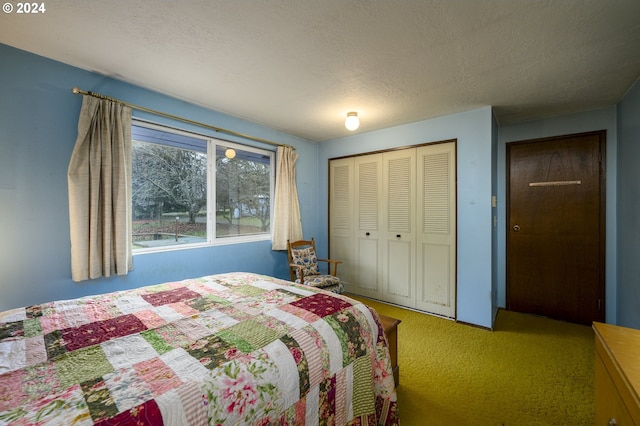 bedroom with a closet, carpet, and a textured ceiling