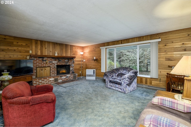 carpeted living room featuring wood walls, a fireplace, a textured ceiling, and a baseboard heating unit