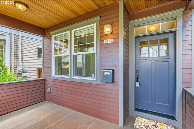 view of exterior entry featuring a porch