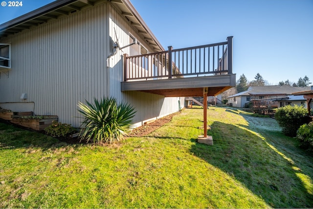 view of home's exterior featuring a lawn and a wooden deck