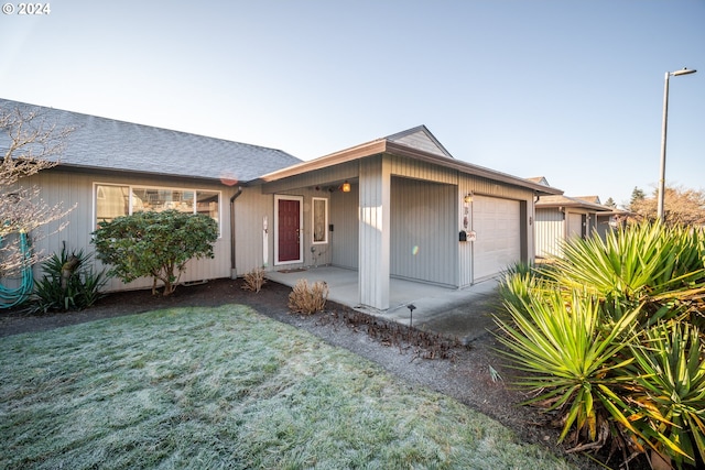 ranch-style house with a front yard and a garage