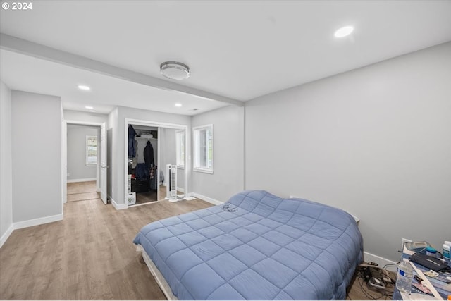 bedroom featuring light wood-type flooring and a closet